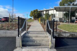 A stairwell with silver handrails leads from a new car park to a new footpath. The footpath is flanked by new landscaping and provides a link to the Maryborough Hospital entrance.