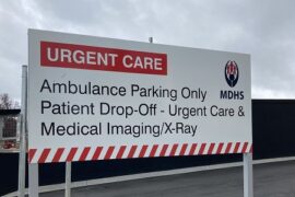 A sign metal sign at the entrance to Urgent Care Centre at Maryborough Hospital. It highlights the area is for ambulance only and patient drop off for the urgent care, medical imaging and x-ray