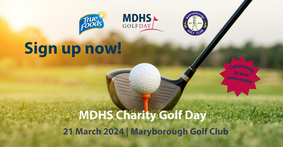 A close up images of a golf ball sitting on a tee on green grass. A golf club sits behind the ball in preparation for a golf swing. The text reads MDHS Charity Golf Day 21 March 2024 Maryborough Golf Club. Sign up now.