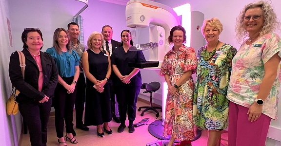 A group of nine people standing in a mammography clinic