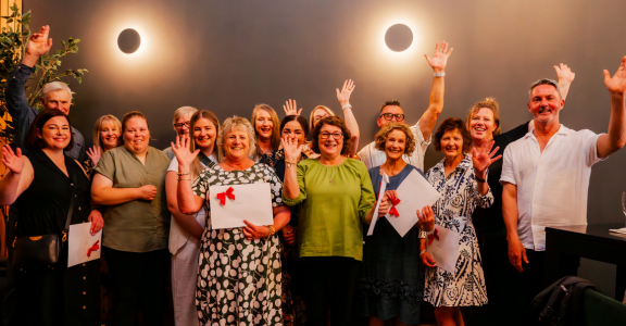 Award winners with hands up in air