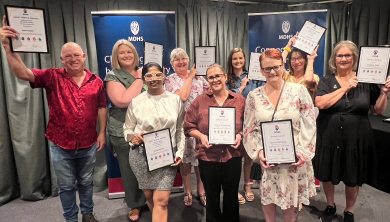 Group of people holding their award certificate frames