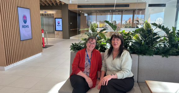Two midwifes sitting in a hospital café.