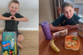 Two kids with their healthy lunchboxes